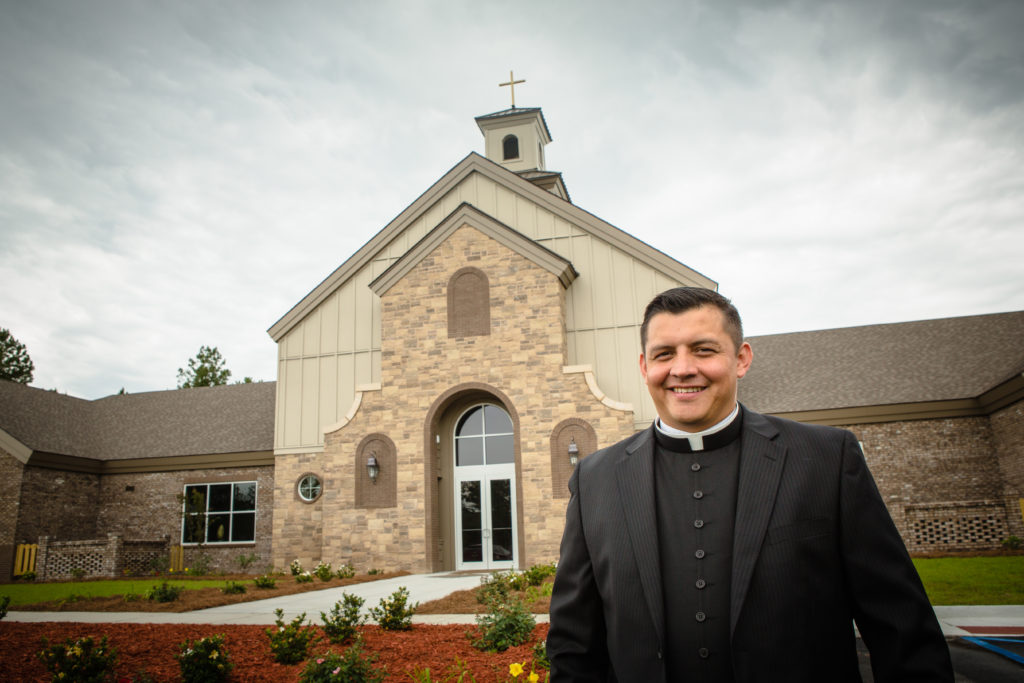 Fr. Freddy Angel stands in front of St. Anthony of Padua church