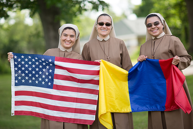 Catholic sisters holding flags 