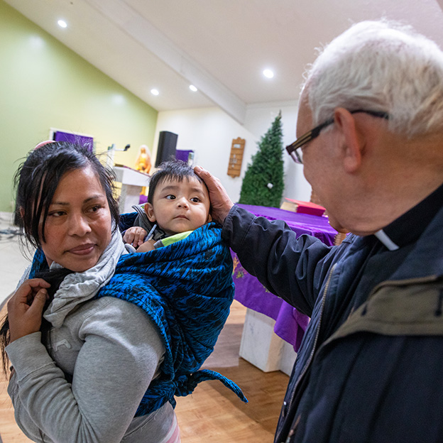 Cardinal Alvaro Ramazzini meet immigrant mother and child