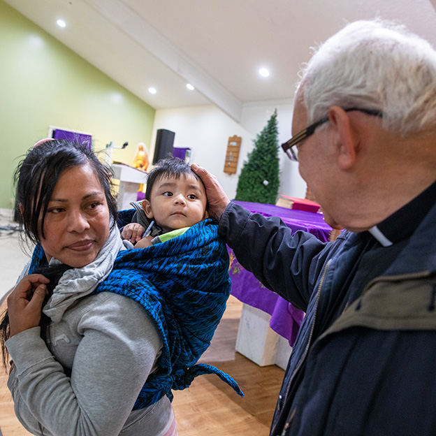 Cardinal Alvaro Ramazzini meet immigrant mother and child 