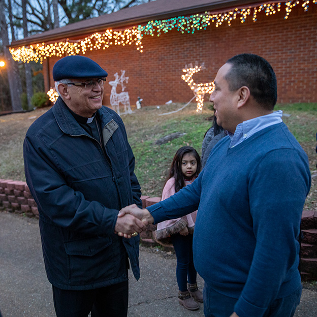 Cardinal Álvaro Ramazzini shakes hands with Fr. Odel Medina