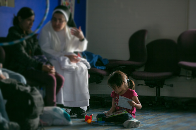 immigrant child playing on the floor 