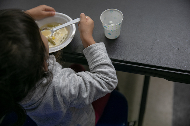 migrant child eating