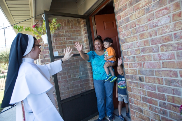 Sister Yelitza waves to a family