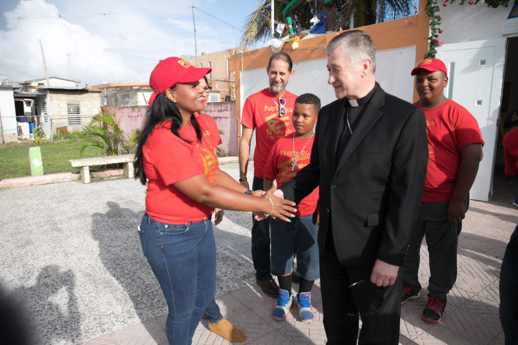 Cardinal Cupich sharing hands with volunteer in Puerto Rico 