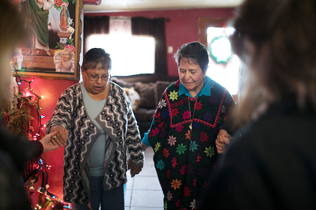 Women praying together at home