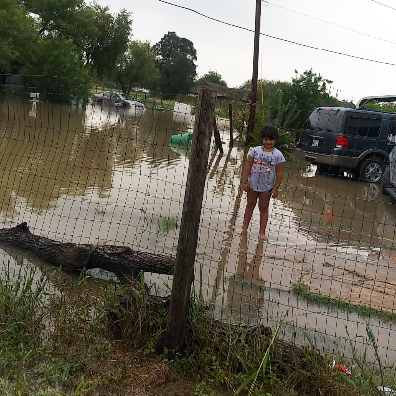 Young girl stands in flooding after Hurricane Hanna