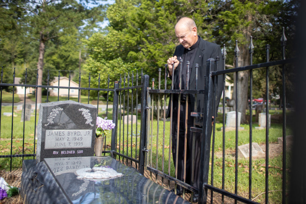 Father Ron Foshage at the grave of James Byrd, Jr.