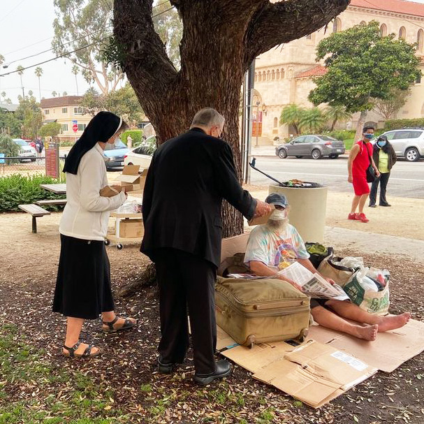 Sister Rose Marie Tulacz, SND distributes solar phone chargers to combat homelessness in park across from St. Monica