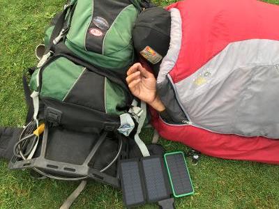 Man experiencing homelessness sleeps next to a phone charger
