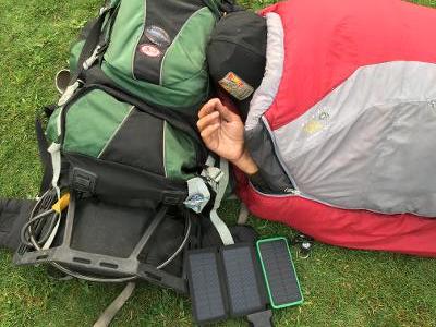 Man experiencing homelessness sleeps next to a  phone charger