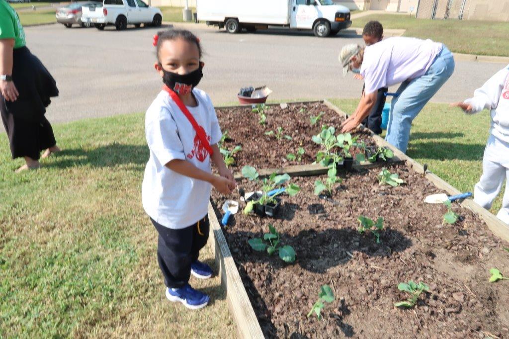 Child planting garden