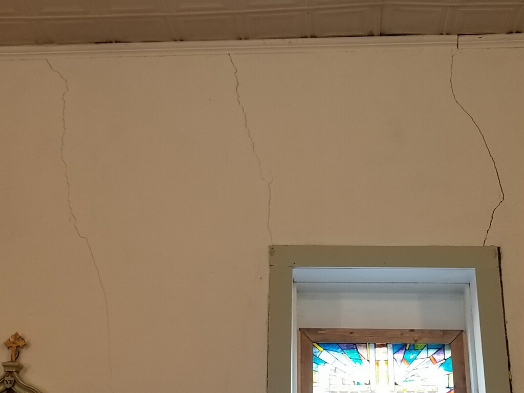 Cracked adobe walls inside of church 